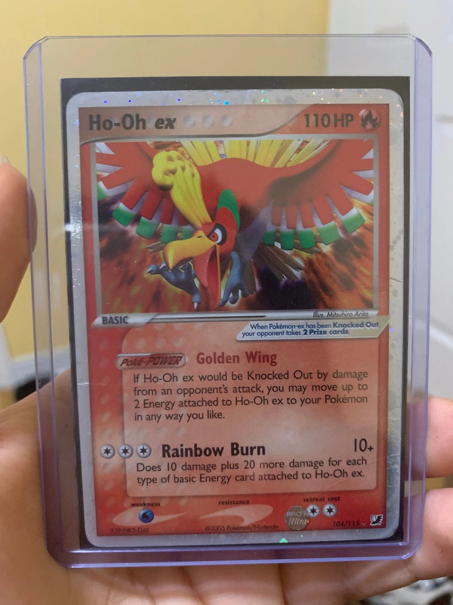 Ho-Oh ex Pokémon trading card in protective case held by hand, collectible hobby item