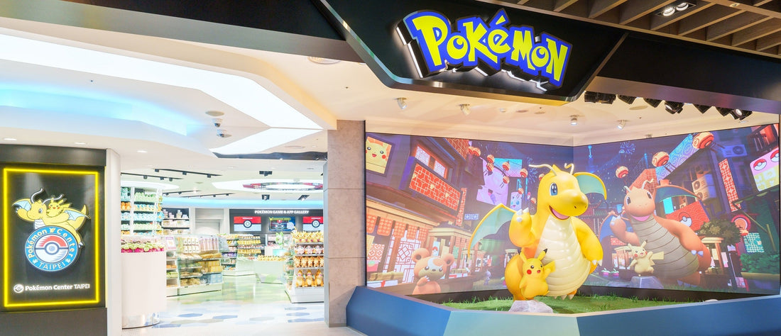 Pokémon Center Taipei storefront with Dragonite and Pikachu statue, collectible products display